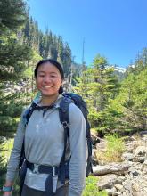 A picture of Jenny Sai standing in front of mountains at Necklace Valley in Skykomish, WA 