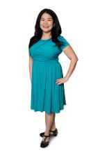 Photo of an Asian woman with long black hair and dark brown eyes in a teal dress.